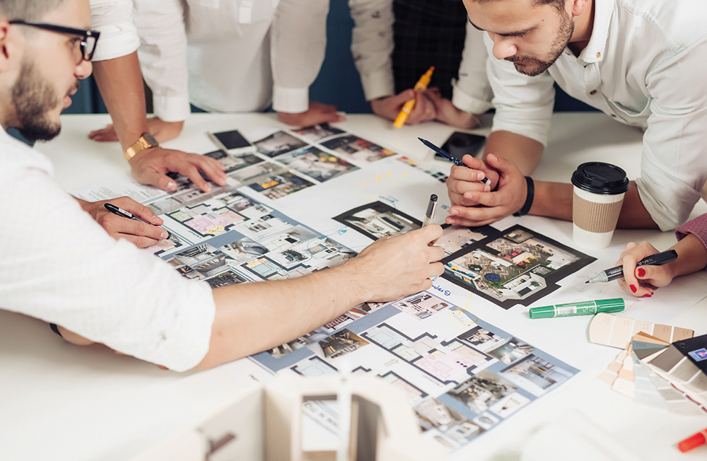 Team,Of,Architects,Working,On,Construction,Plans